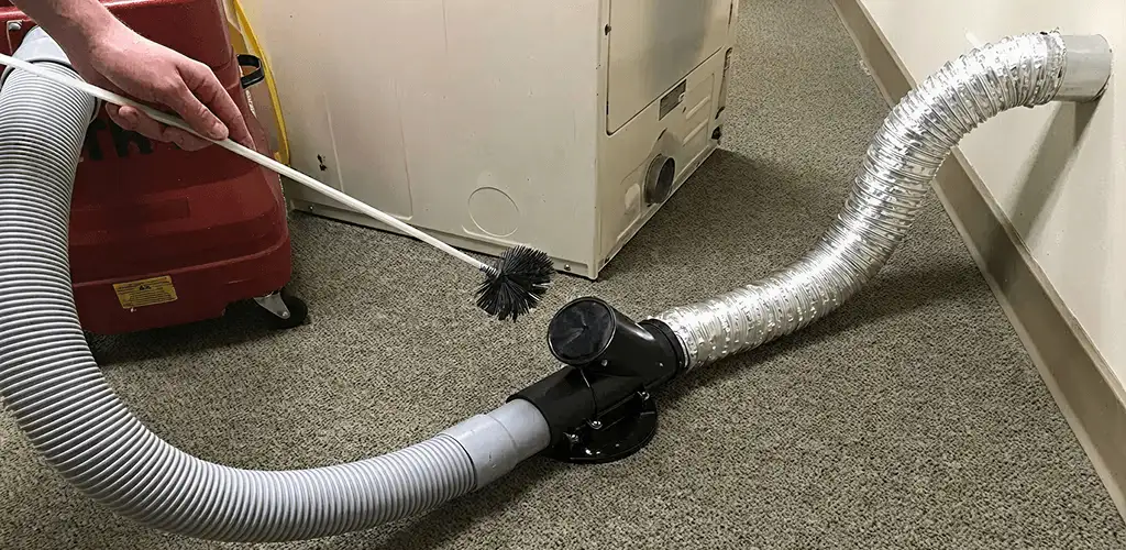 Dryer vent cleaning service removing lint from a dryer duct connection in Fresno, CA