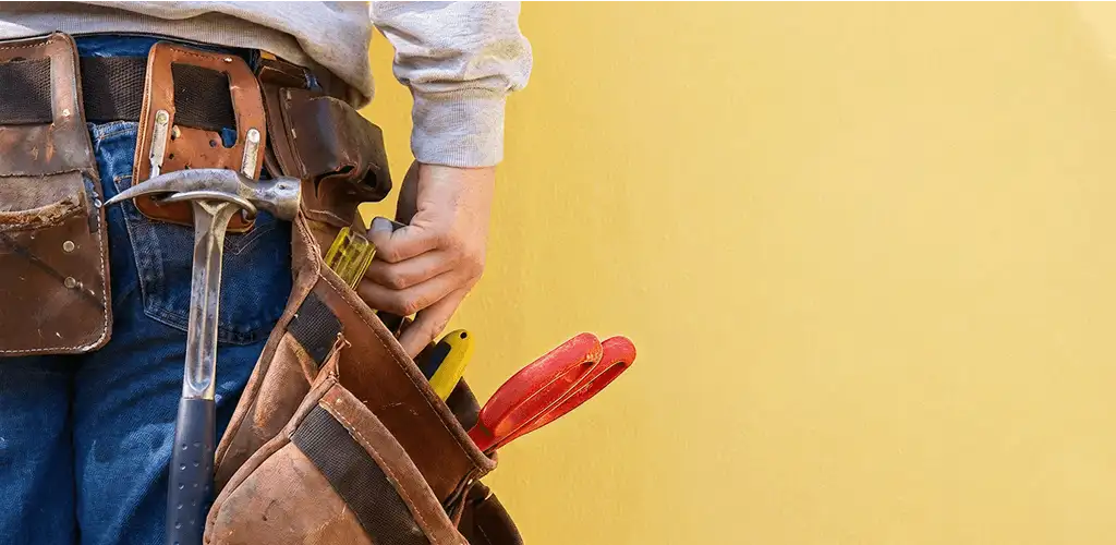 Handyman with tool belt ready for home repairs and maintenance in Fresno, CA